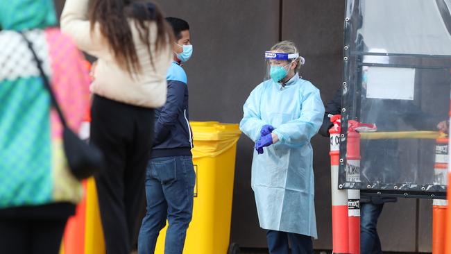 Residents line up for COVID testing near an apartment block in Southbank. Picture: NCA NewsWire / David Crosling