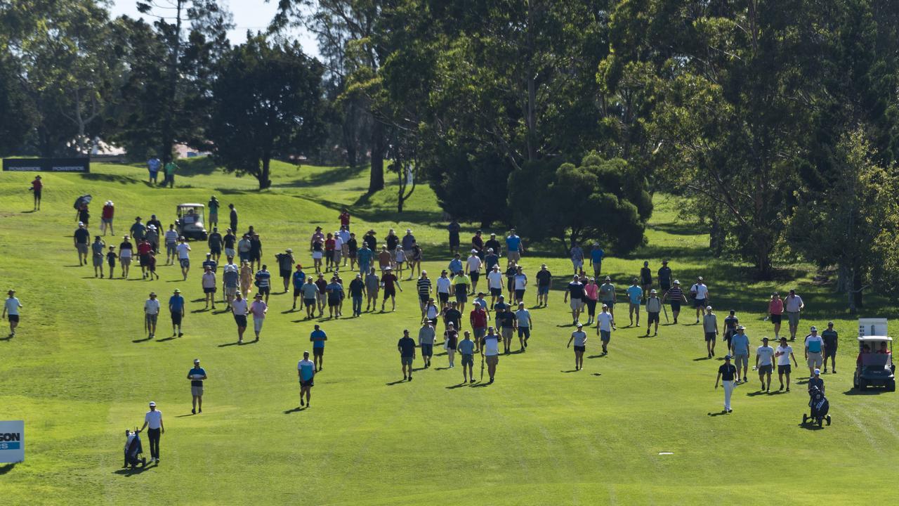 The gallery follows the final group down the 18th fairway in the Queensland PGA Championship final round at City Golf Club on Sunday. Picture: Kevin Farmer