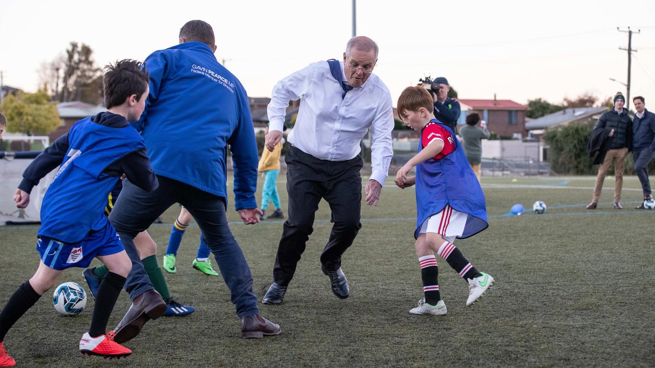 Scott Morrison plays soccer during a campaign trail visit in Devonport. Picture: Jason Edwards