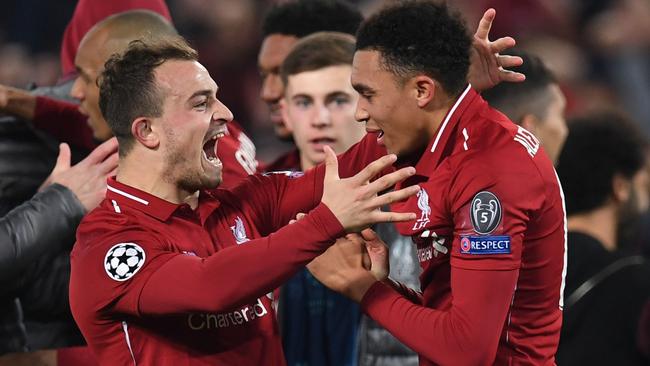 Xherdan Shaqiri celebrates victory with defender Trent Alexander-Arnold. Picture: AFP
