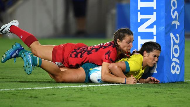 Australia’s Charlotte Caslick is tackled on the tryline by Jasmine Joyce of Wales. Picture: AFP