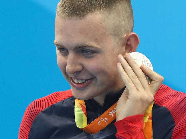 RIO DE JANEIRO, BRAZIL - SEPTEMBER 10: Silver medalist Tharon Drake of the United States listens to the sound of his medal on the podium at the medal ceremony for the Men's 400m Freestyle - S11 on day 3 of the Rio 2016 Paralympic Games at the Olympic Aquatic Stadium on September 10, 2016 in Rio de Janeiro, Brazil. (Photo by Buda Mendes/Getty Images)