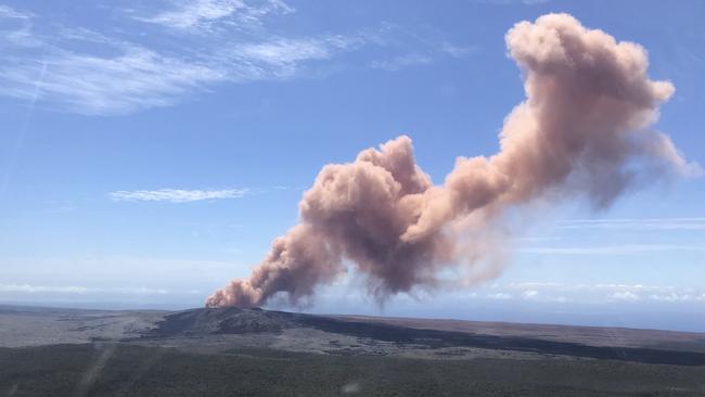 In this photo provided by the U.S. Geological Survey, red ash rises from the Puu Oo vent on Hawaii's Kilauea Volcano after a magnitude-5.0 earthquake struck the Big Island, Thursday, May 3, 2018 in Hawaii Volcanoes National Park. The temblor Thursday is the latest and largest in a series of hundreds of small earthquakes to shake the island's active volcano since the Puu Oo vent crater floor collapsed and caused magma to rush into new underground chambers on Monday. Scientists say a new eruption in the region is possible. (Kevan Kamibayashi/U.S. Geological Survey via AP)