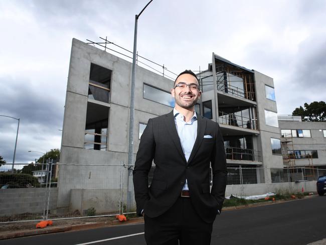 Hobart City Council Alderman Simon Behrakis standing in front of a new multi-residential development in Sandy Bay. Picture: LUKE BOWDEN