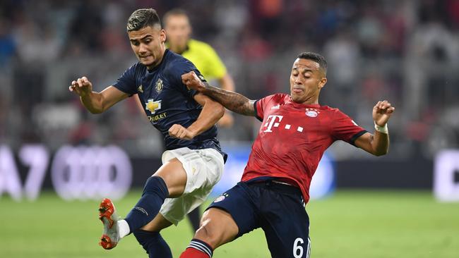 Andreas Pereira (L) and Thiago Alcantara (R) go in for a big tackle.