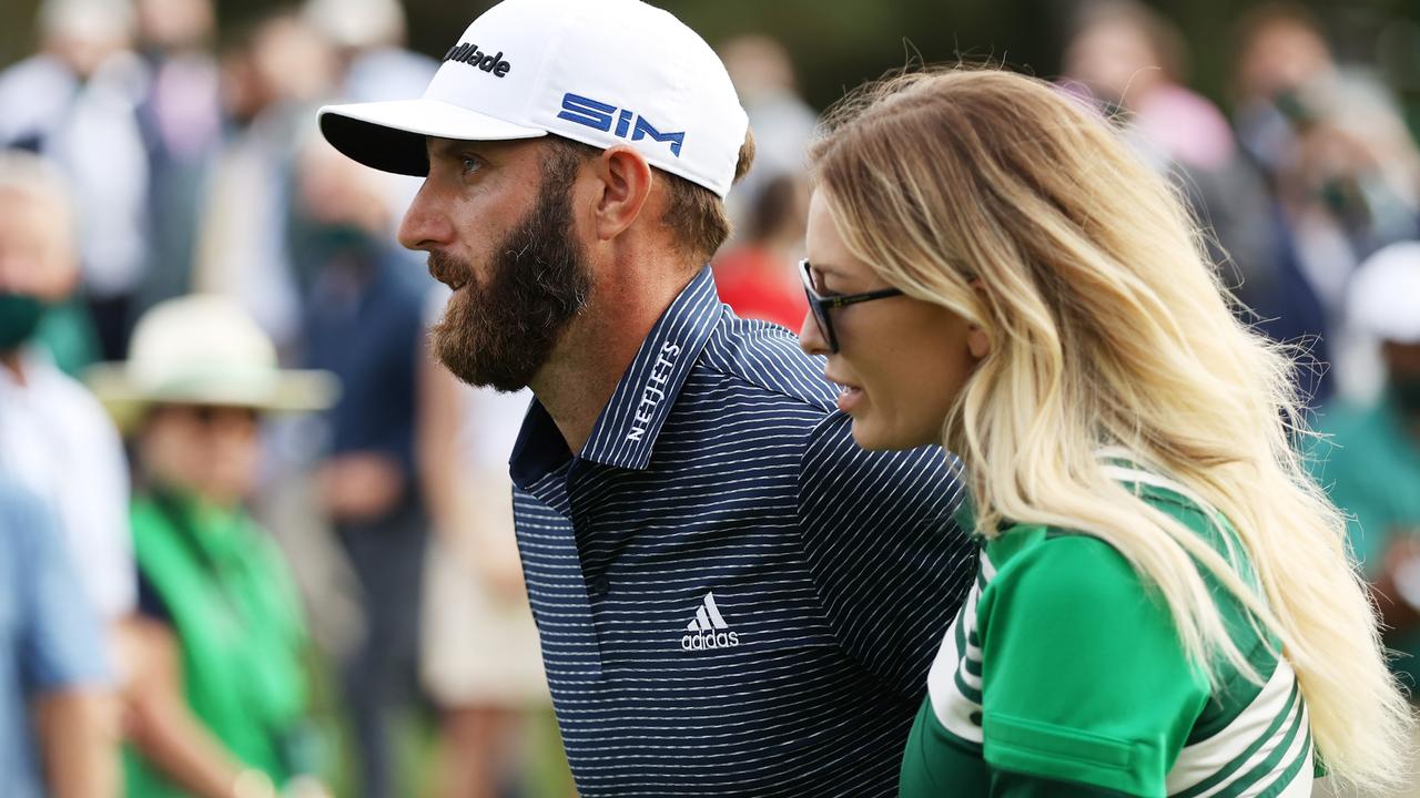 Dustin Johnson and fiance Paulina Gretzky walk off the 18th green after winning the Masters at Augusta National. (Photo by Patrick Smith/Getty Images)