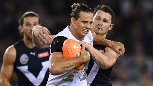 Patrick Dangerfield tackles Nat Fyfe during the AFL's bushfire relief match.