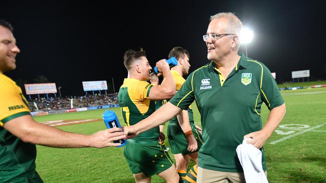 Prime Minister Scott Morrison is seen carrying water to the Australian Men's Rugby players at ANZ Stadium in Suva, Fiji, Friday, October 11, 2019. Prime Minister Scott Morrison is visiting Fiji on a diplomatic mission over two days. (AAP Image/David Mariuz) NO ARCHIVING