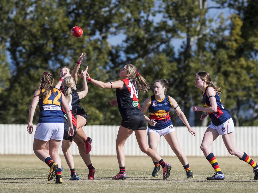 Alexandra Walters (centre) attempts to gain possession for South Toowoomba against University in AFL Darling Downs senior women's round 9 at Heritage Oval, Saturday, June 19, 2021. Picture: Kevin Farmer