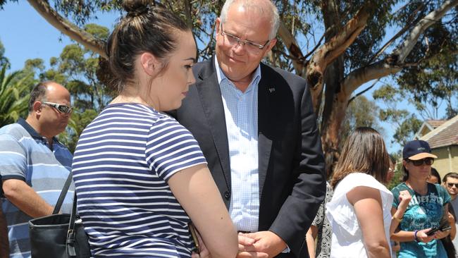 PM Scott Morrison speaks with a woman at the tribute site. Picture: Andrew Henshaw