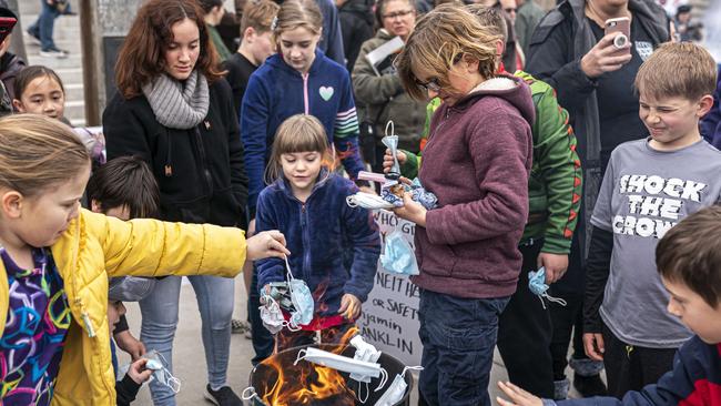 The young join in at a mask buring in Boise, Idaho, on Saturday. Picture: AFP