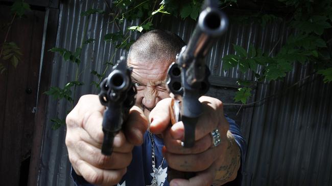 Setting the scene in the film Pinball where he starred as himself, Mark ‘Chopper’ Reid loaded up and took aim at Jake Nowakowski’s lens on the set of the movie. Picture: Jake Nowakowski