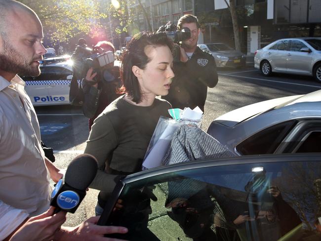 Jack Budge helps his sister Sarah Budge get into a car. Picture: Richard Dobson