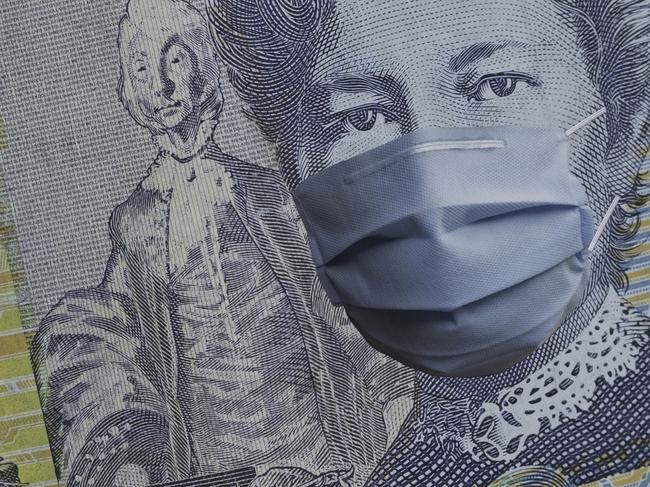 COVID-19 coronavirus in Australia, australian dollar money bill with face mask. COVID global stock market affection. World economy hit by corona virus outbreak. Financial crisis and coronavirus pandemic concept. Istock