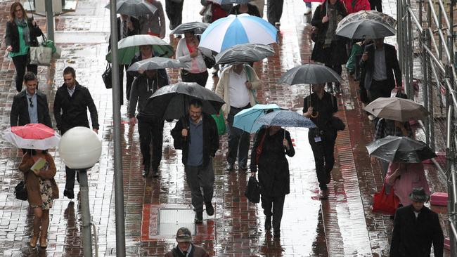 Pedestrians walking in Adelaide city in the rain. Picture: Stephen Laffer