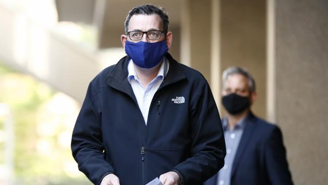 Victorian Premier Daniel Andrews wears a face mask as he walks in to the daily briefing on July 19.