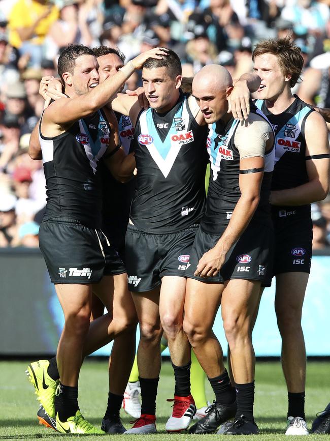 Port Adelaide players congratulate Tom Rockliff on his first goal in Power colours in Round 1. Picture Sarah Reed