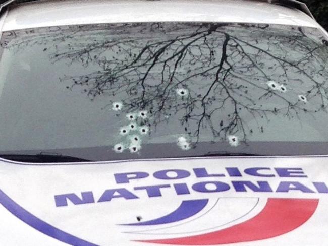 Damage ... a police car riddled with bullets. Picture: AFP