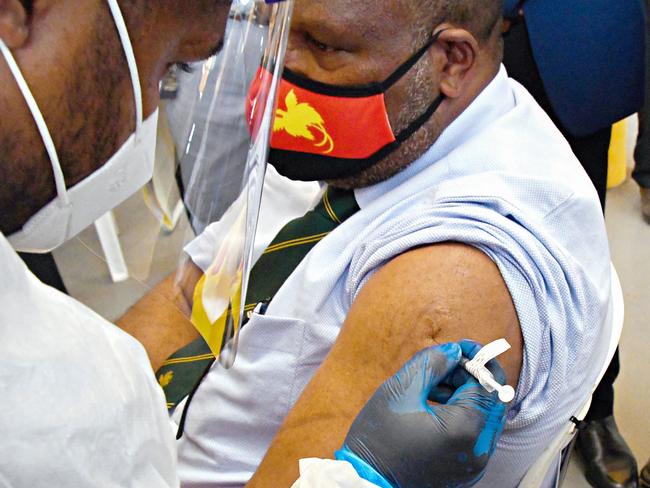 This photo taken on March 30, 2021 shows Papua New Guinea's Prime Minister James Marape receiving a dose of the AstraZeneca Covid-19 vaccine in Port Moresby, as Papua New Guinea's health minister on April 1 called disinformation spread on Facebook the "biggest challenge" to efforts to curb the rampant spread of Covid-19 in the poor pacific nation. (Photo by Gorethy KENNETH / AFP)