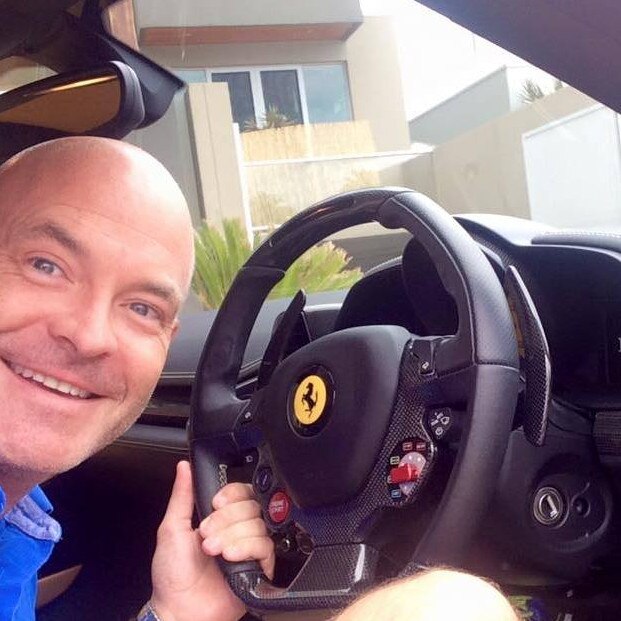 Sunshine Coast businessman Gordon Smith behind the wheel of a Ferrari.