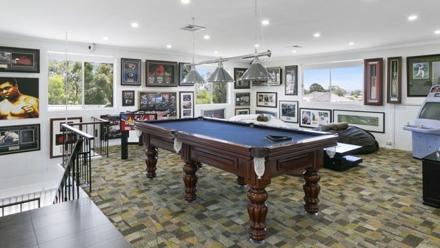 The luxury home has six bedrooms, a pool room, three-car garage and an outdoor pizza oven.