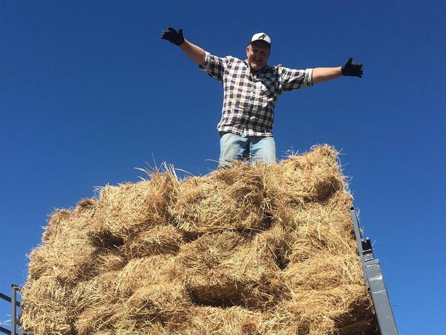 Paul Aitken with some of the hay to be trucked to the mainland