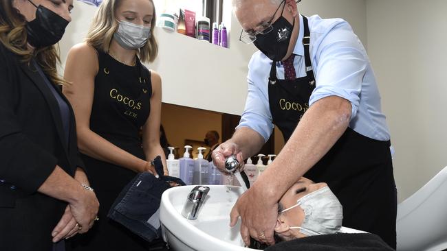 Prime Minister Scott Morrison tried his hand at hair washing. Picture: NCA NewsWire / Andrew Henshaw