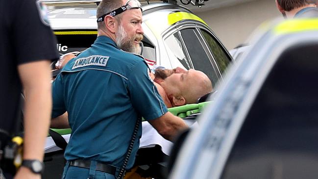 Ricky Cowan, 48, being taken to an ambulance on the day he murdered his de facto of 18 years Crystal Ratcliffe. After killing her, Cowan turned the knife on himself. Picture: Marc McCormack