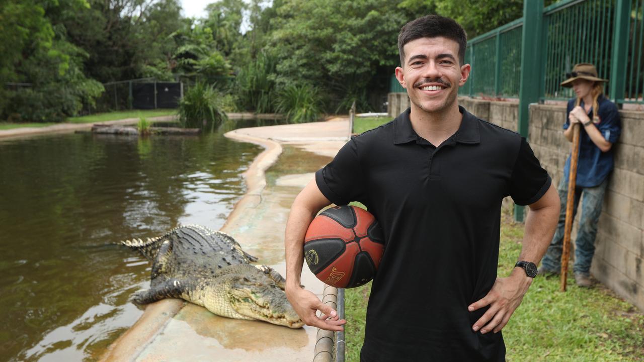 Freddy Webb shows off his basketball skills with monster croc, Speckles, at Crocodylus Park. Picture: Sam Lowe