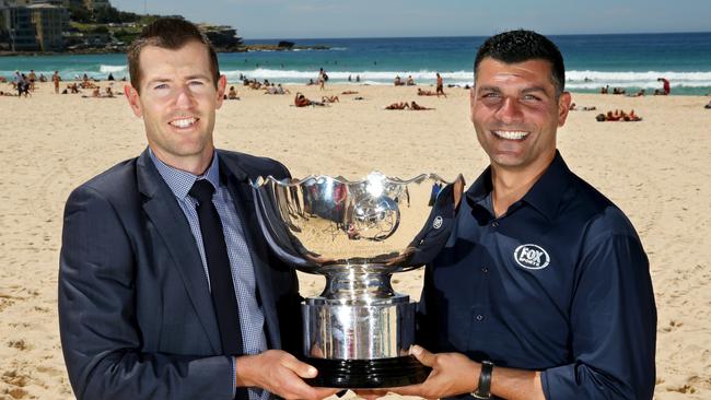 Brett Emerton and Fox Sports presenter John Aloisi with the Asian Cup trophy at Bondi.