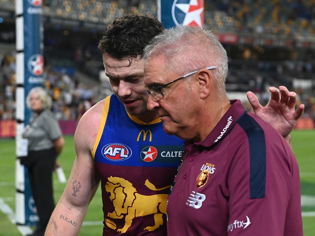 Lachie Neale of the Lions walks off the field with head coach Chris Fagan after their defeat to Collingwood. Picture: Albert Perez/AFL Photos via Getty Images.