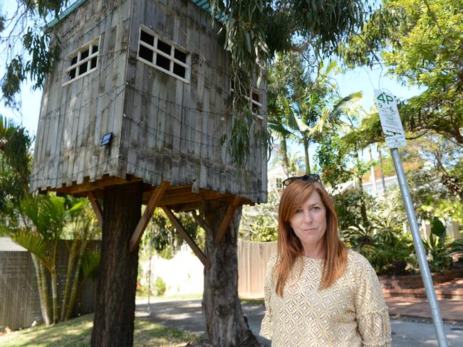 Byron Bay mother Mellanie Coppin with the treehouse outside her home. A lease for the use of the road reserve area will go back before Byron Shire Council soon.