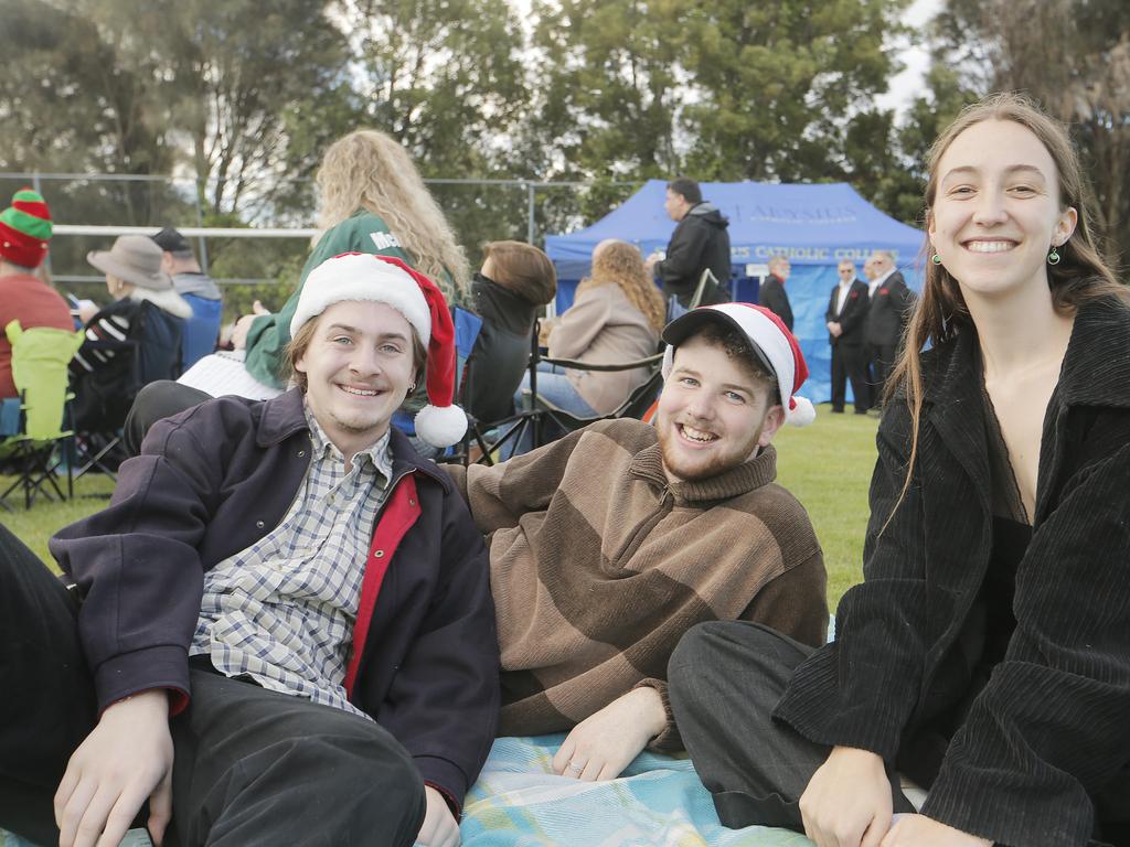 SOCIALS Oscar Batchelor of Rose Bay, left, Finn Carter of West Hobart and Kate Goyen of Kingston at the Carols on the Hill, Guilford Young College, West Hobart. Picture: MATHEW FARRELL