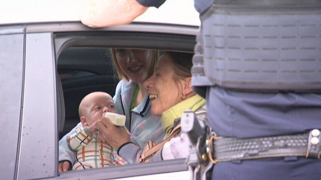 Mum feeds her four-month old baby in the back of a police car after it was taken when her car was stolen . Picture: NINE NEWS