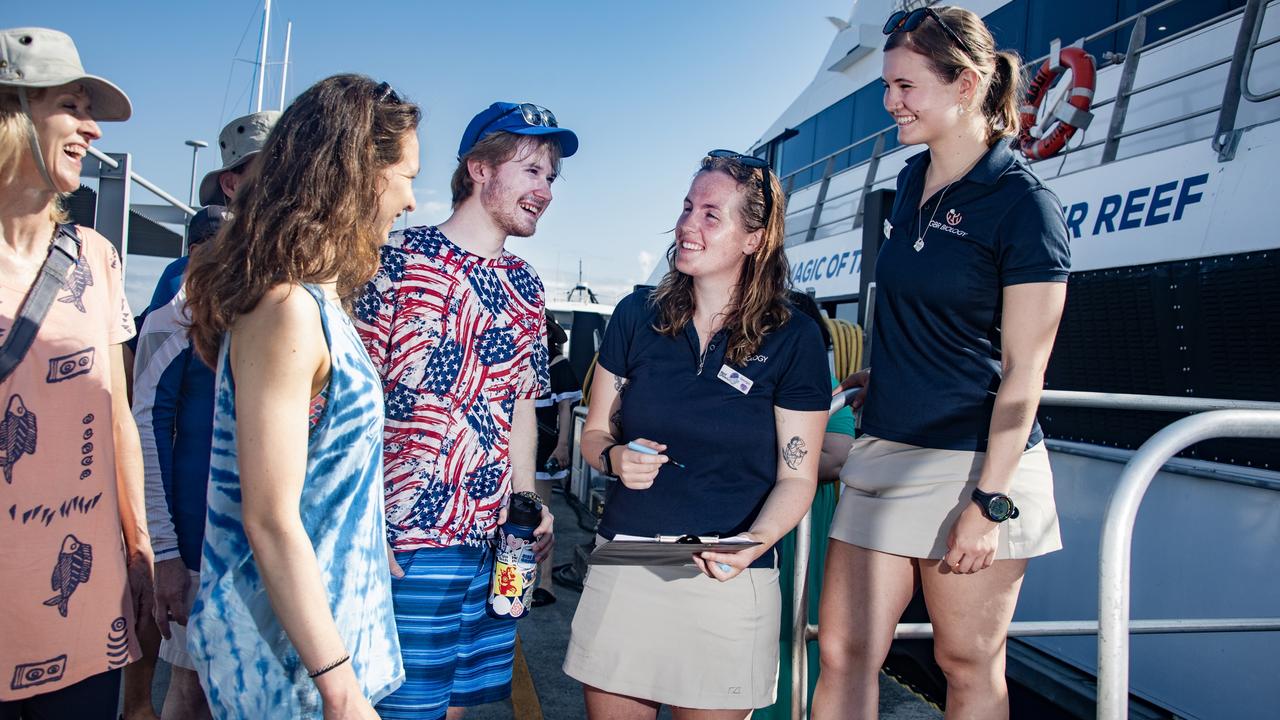 Reef Magic Marine Biologists Tamila Heath (right) and Georgia Blackler (2nd from right) greet the Lauenger family from Florida. Picture: Brian Cassey