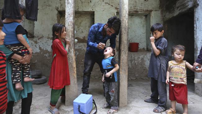 An Afghan health worker gives a vaccination to a child during a polio campaign in the old city of Kabul, Afghanistan. Picture: Rahmat Gul