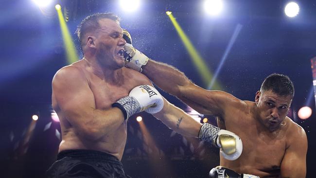 Justin Hodges (R) lands a punch on Nathan Ross. Picture: Mark Evans/Getty