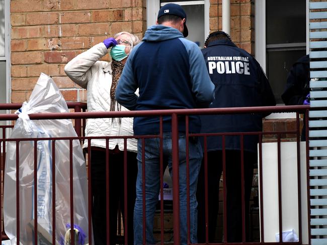 AFP officers search the flat in Ascot Vale. Picture: Nicole Garmston