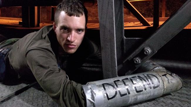 Nic Avery, a 27-year-old student from Sydney, locked to the machinery at Adani's Abbot Point Coal terminal.