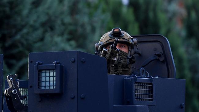 A police officer looks on as Kosovo police officers search a restaurant and building in northern Serb-dominated part of ethnically divided town of Mitrovica on September 29, 2023. Picture: STRINGER / AFP