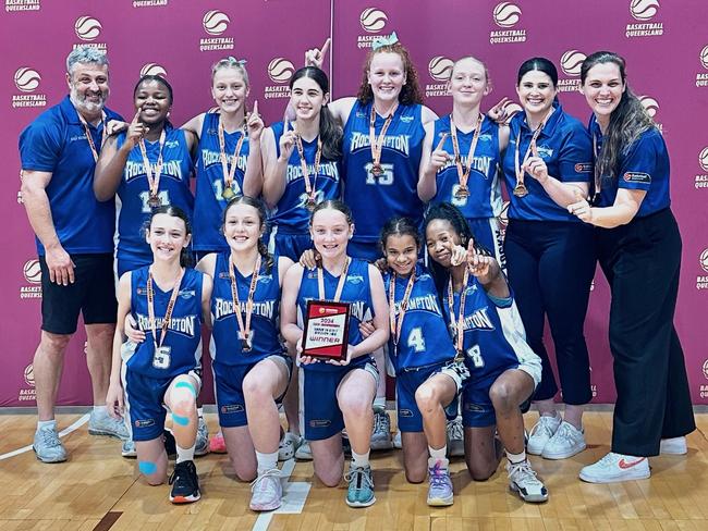 The Rockhampton Cyclones celebrate after winning Division 2 of the state under-14 girls basketball championships played in their home city.