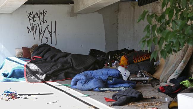 Squatters are living under the Ringwood Gateway Bridge, among heaps of stuff dumped in a house next to Hungry Jacks. Picture: Stuart Milligan