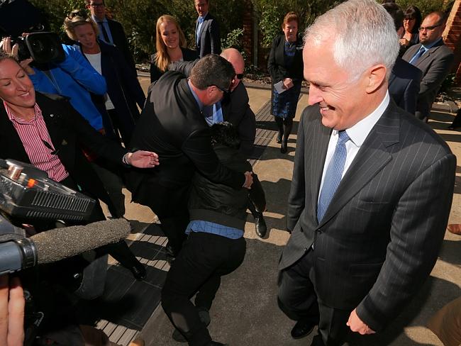 Chas from “The Chaser” collapses in a stunt at the feet of the PM, as police pull him away after Prime Minister. Picture: Lyndon Mechielsen