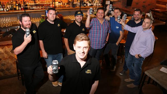 Members of the Beer Buddy group raise a glass to their own brew.