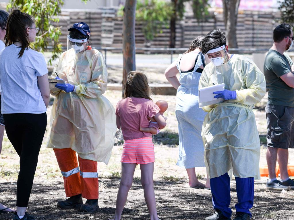 Medical staff talk to people at a walk in station at Parafield Airport in Adelaide during day one of total lockdown across the state. Picture: AFP