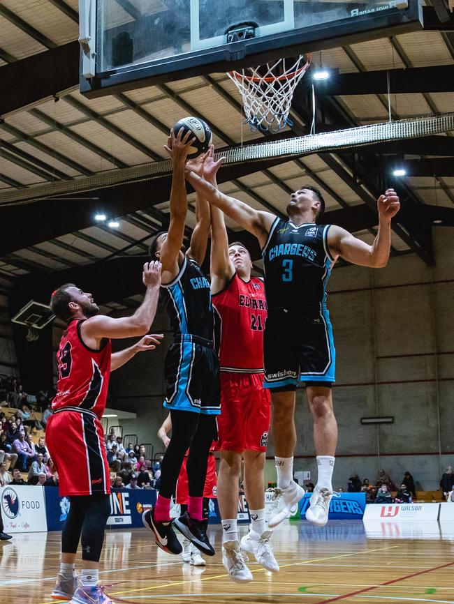 Jonathan Mines, left, and Ambrose Eugster compete for the ball for the Hobart Chargers. Picture: Linda Higginson