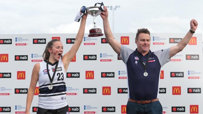 Northern Knights captain Gabby Newton and coach Marcus Abney-Hastings lift the NAB League Girls premiership cup.