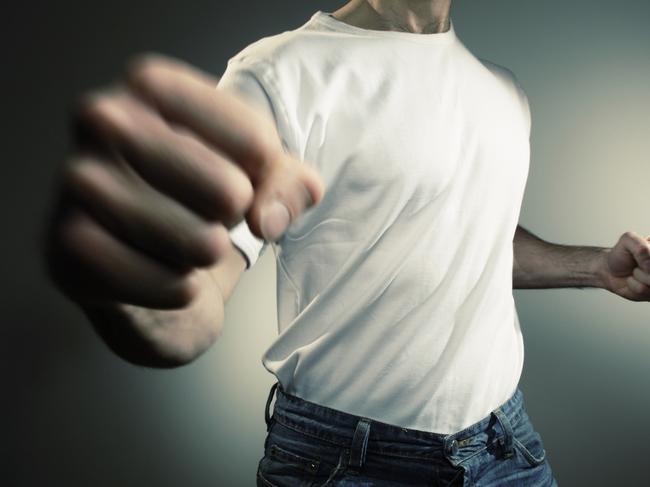 man in white t shirt and jeans throwing punch with motion blur -add text/graphics