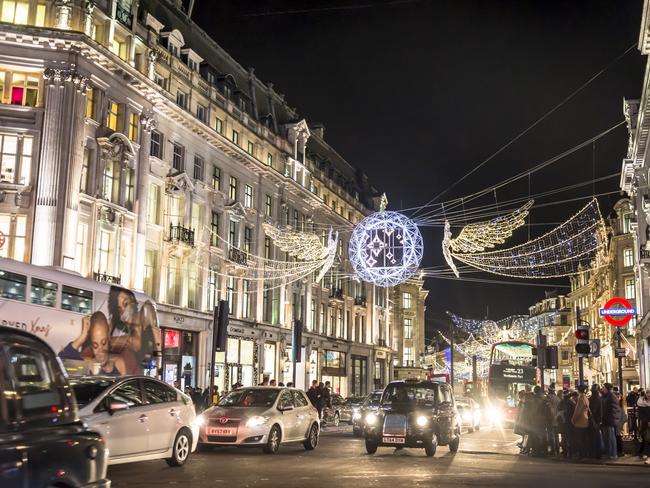 Oxford Street busy with traffic and people under overhanging Christmas decoration in central London, England, UK. Picture: iStockDoc Holiday, Lisa Mayoh, Escape