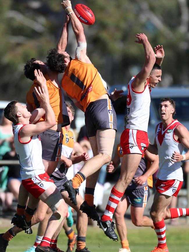 Giants player Jake Garvey thumps the ball away from Ararat’s Tex Korewha.